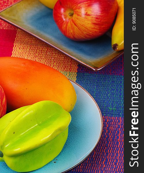 A few fruits with a colorful background. A few fruits with a colorful background