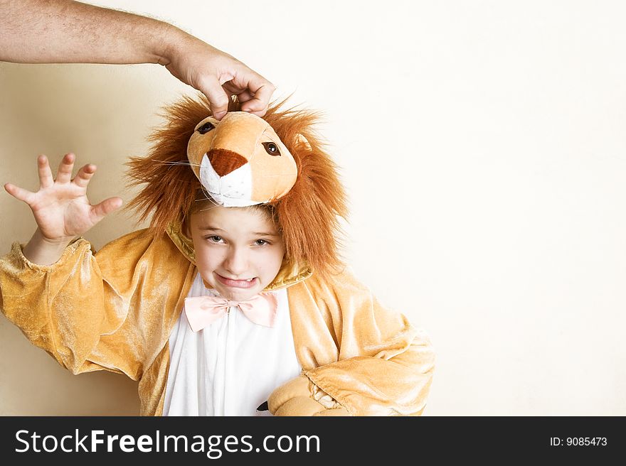 Playful young boy wearing a lion costume. Playful young boy wearing a lion costume