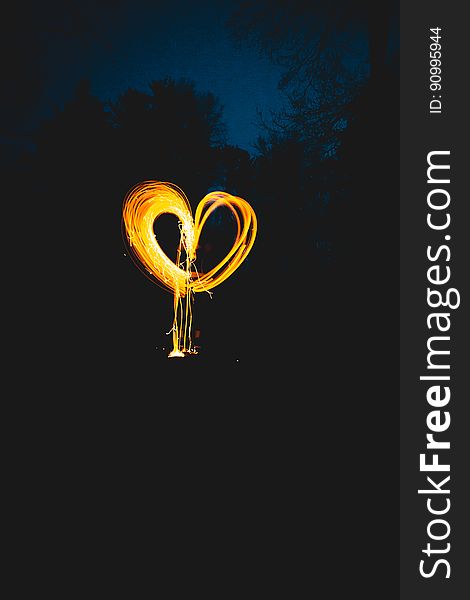 Gold heart shape tracing produced by a moving light source (torch for example) and extended exposure on a dark sky background. Gold heart shape tracing produced by a moving light source (torch for example) and extended exposure on a dark sky background.
