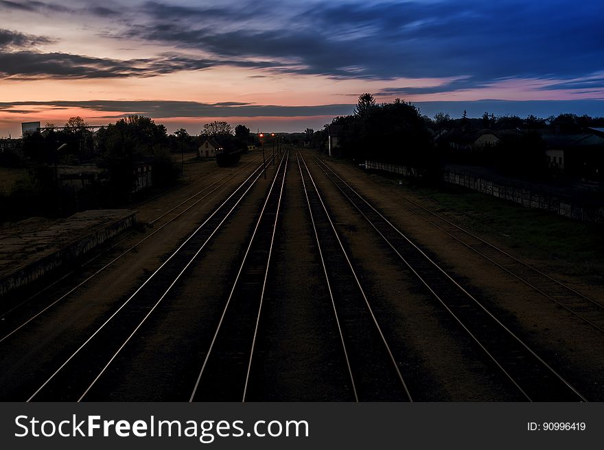 A railroad with four tracks at dusk. A railroad with four tracks at dusk.