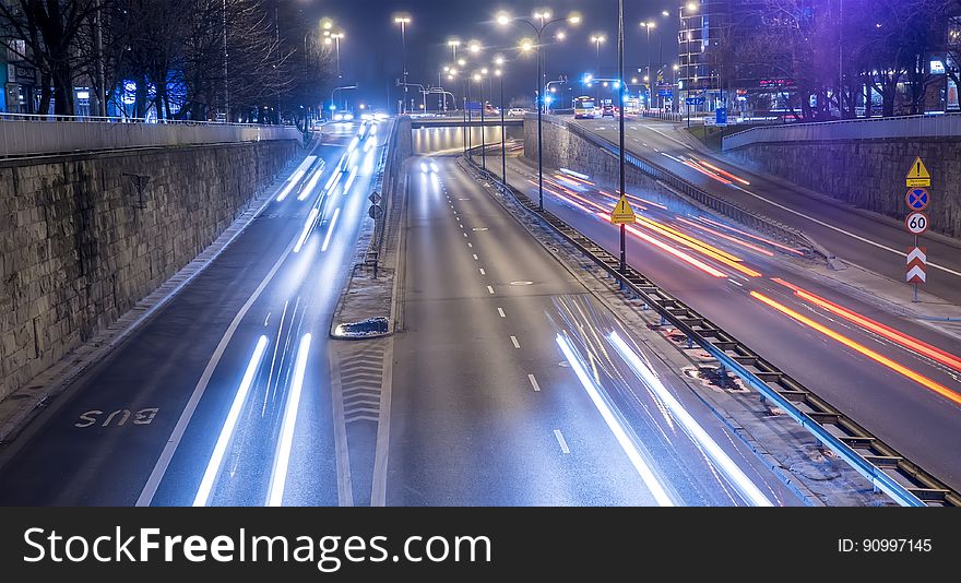 A view of a city with light trails of the traffic. A view of a city with light trails of the traffic.