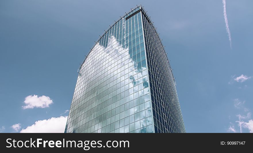 A skyscraper with glass facade against the blue skies. A skyscraper with glass facade against the blue skies.