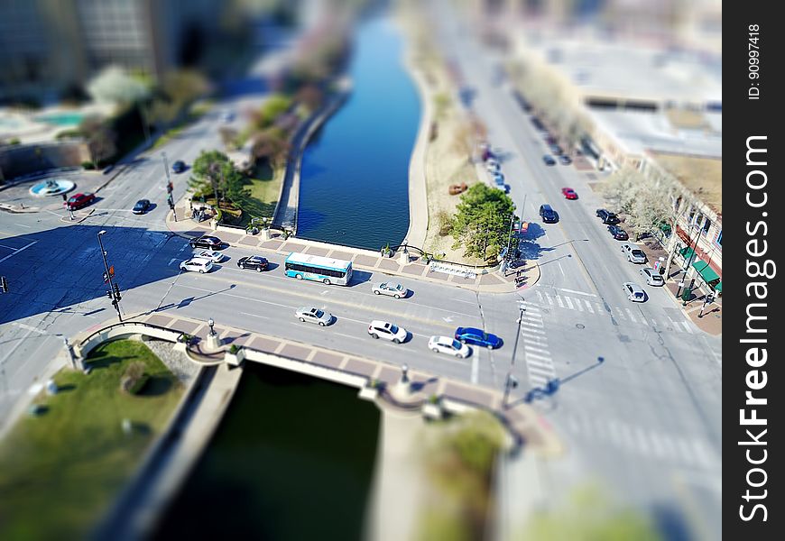 Aerial view over traffic on urban streets and bridge over river. Aerial view over traffic on urban streets and bridge over river.