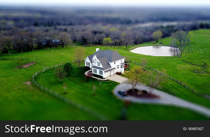 Aerial view of house in green field