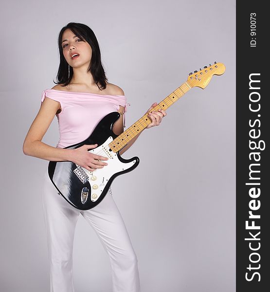 An Asian woman holding a guitar. An Asian woman holding a guitar