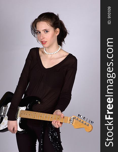 A Young woman holding an electric guitar. A Young woman holding an electric guitar.