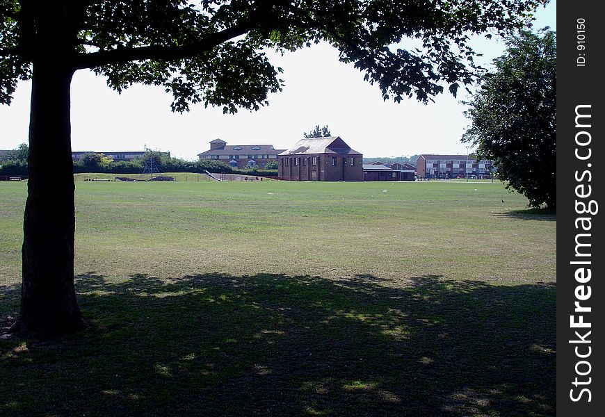 A hotel in a field in the outskirts of London under the shade of a tree