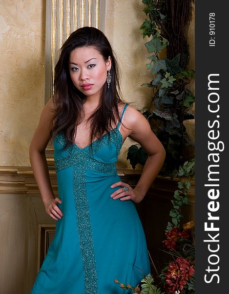 A beautiful Asian model in a green evening dress. A beautiful Asian model in a green evening dress.