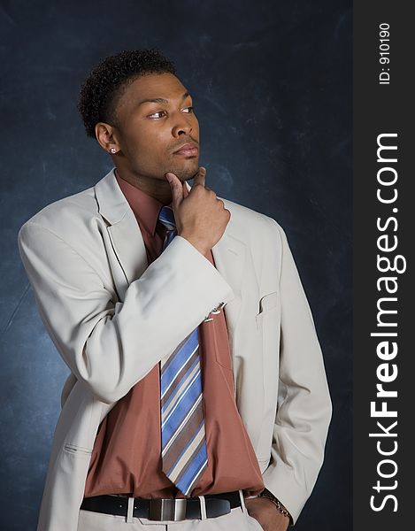 A man in a suit, looking off to the side, in deep thought