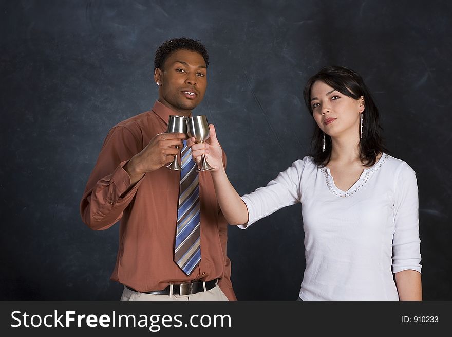 A man and woman toasting with two goblets. A man and woman toasting with two goblets