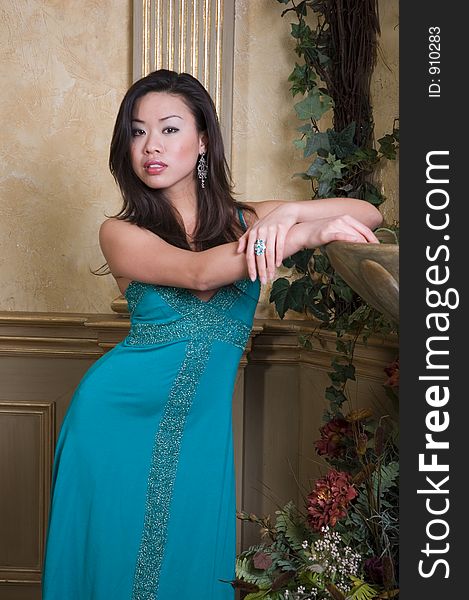 A beautiful Asian model in a green dress