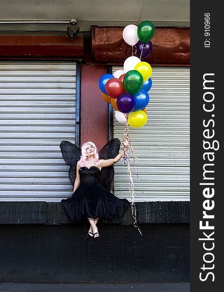 Fairy with balloons in an urban setting