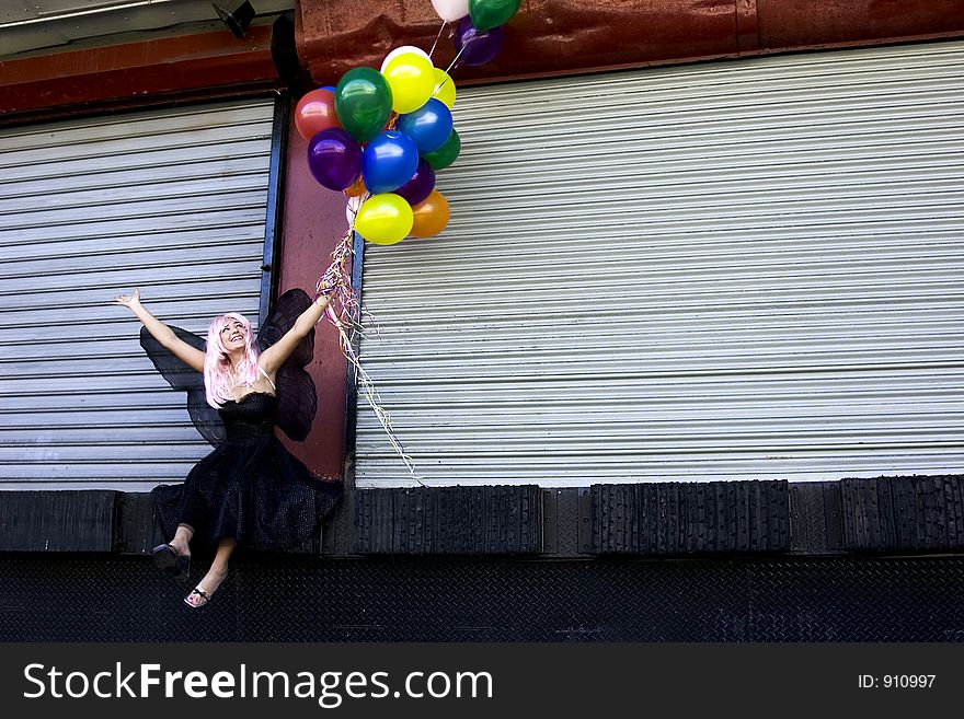 Fairy with balloons waiving at passersby