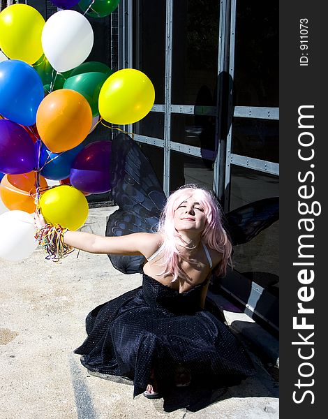 Fairy with balloons enjoying the sun. Fairy with balloons enjoying the sun