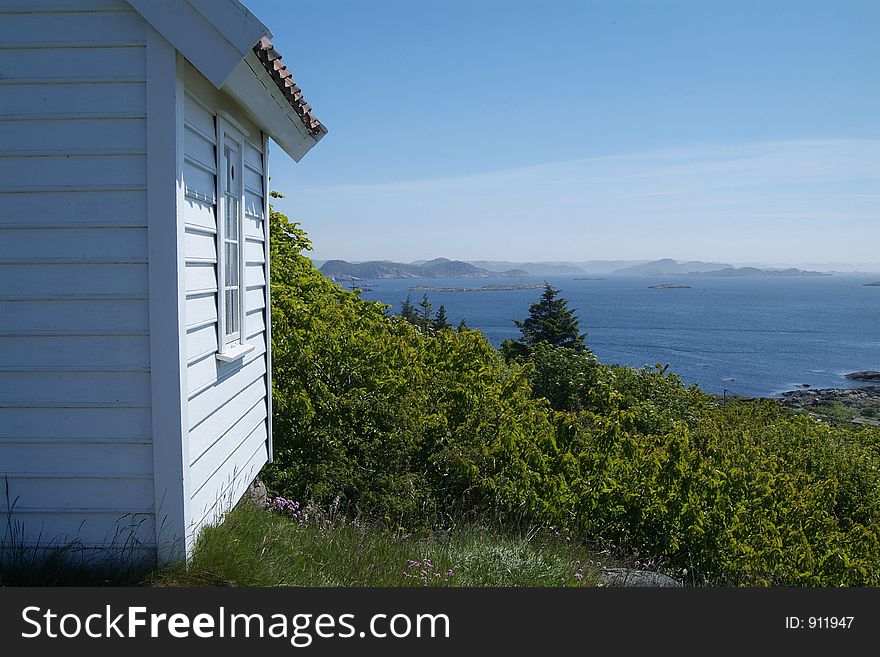 Small, white, wooden cabin overlooking the archipelago outside Loshavn near Farsund in Vest-Agder on the south coast of Norway. Small, white, wooden cabin overlooking the archipelago outside Loshavn near Farsund in Vest-Agder on the south coast of Norway