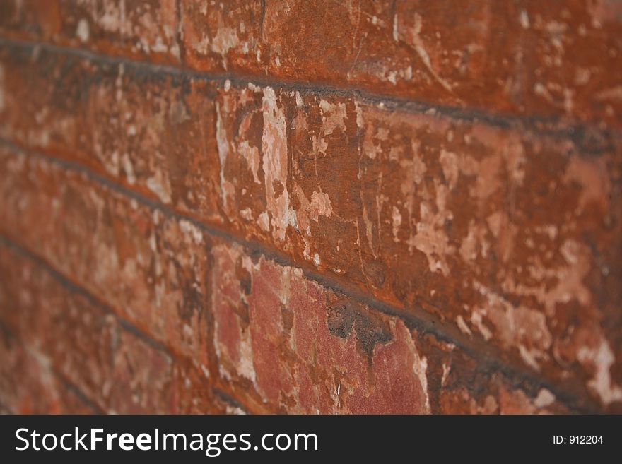 Old red brick wall with remenants of a white wash