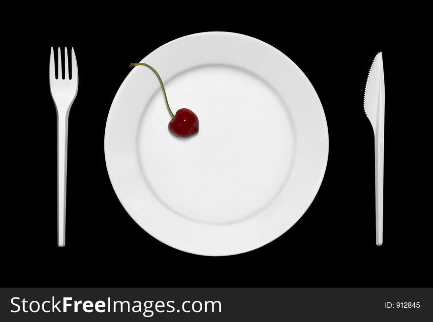 Cherry on the plate together with cutlery. Cherry on the plate together with cutlery