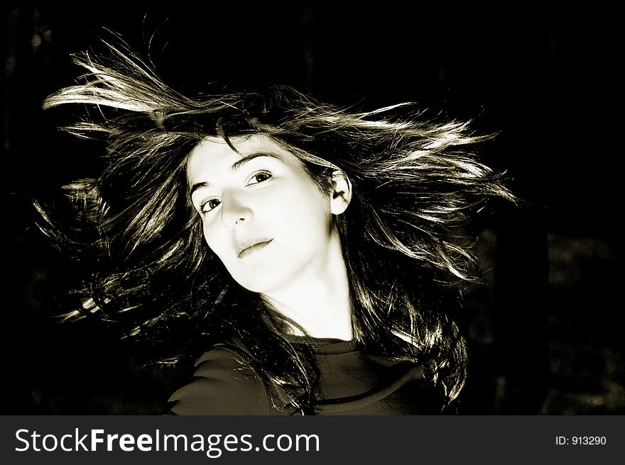 Woman shaking is hair (toned in ps)