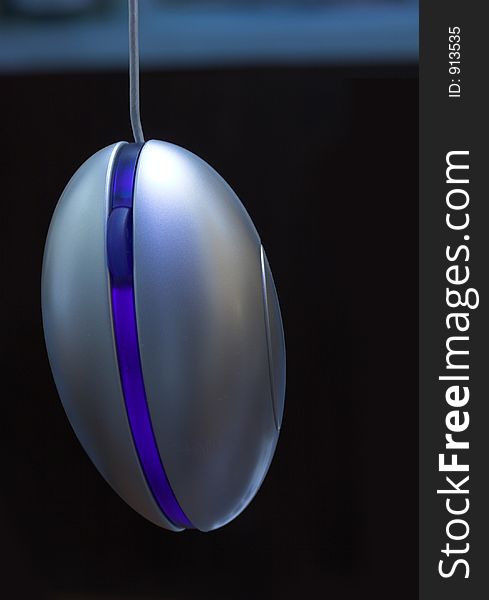Blue Optical mouse in a dark background