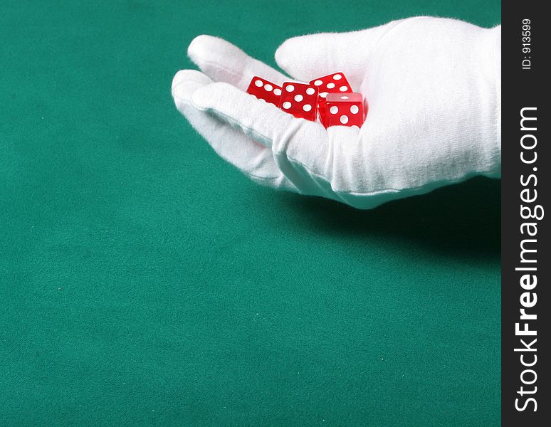 Dices being thrown in a craps game, or yatzee or any kind of dice involved game, Dices are a clear red color on a green felt table. Dices being thrown in a craps game, or yatzee or any kind of dice involved game, Dices are a clear red color on a green felt table