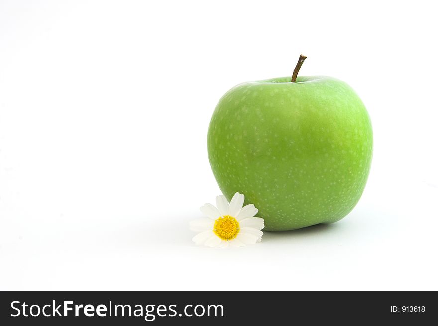 Green Apple isolated in a white background with flowers and reflection. Green Apple isolated in a white background with flowers and reflection