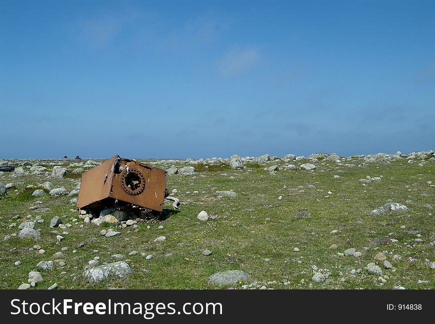 A piece of rusty machinery left on the grass at Lista, the south of Norway. A piece of rusty machinery left on the grass at Lista, the south of Norway