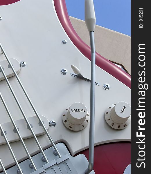 A photograph of a red electric guitar close up. A photograph of a red electric guitar close up