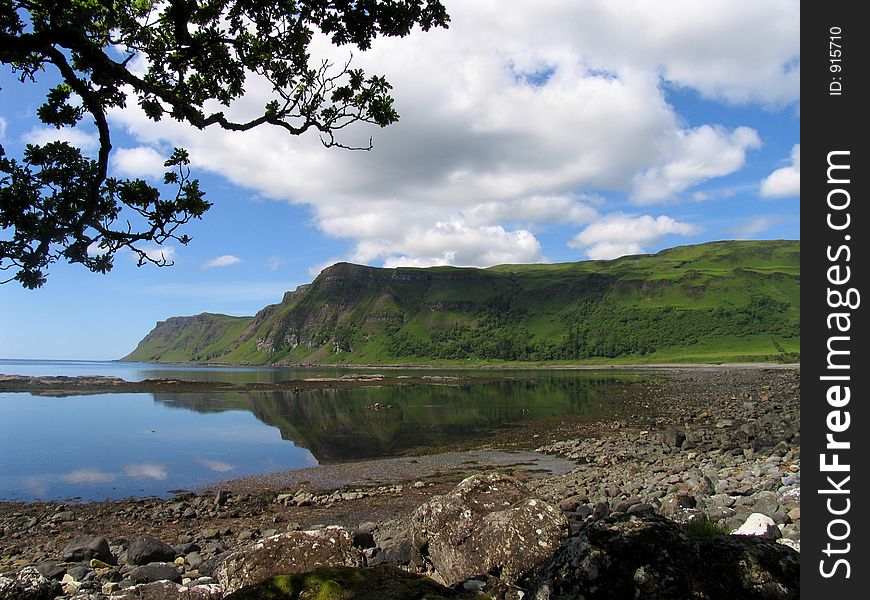 Seascape on the Scottish island of Mull, with oak tree branches in foreground. Seascape on the Scottish island of Mull, with oak tree branches in foreground