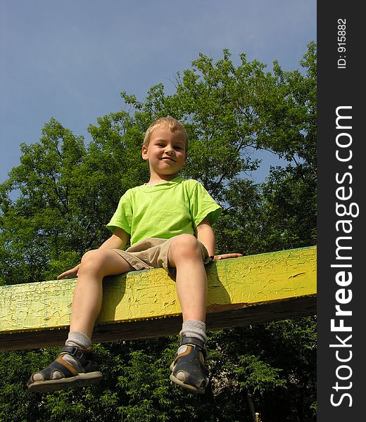 Child sit on log and sky. Child sit on log and sky