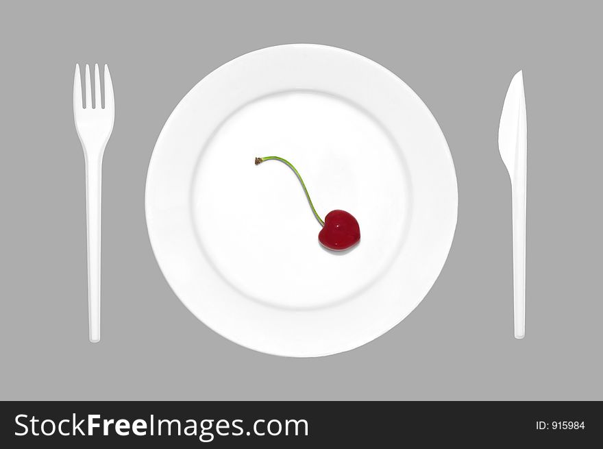 Cherry on the plate together with cutlery. Cherry on the plate together with cutlery