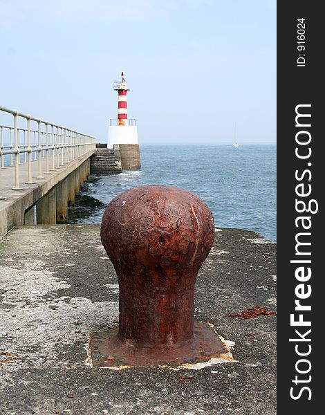 Ships and boats navigate their way inland by the red and white beacon and then can moor by tying their lines against these large bollards. Ships and boats navigate their way inland by the red and white beacon and then can moor by tying their lines against these large bollards
