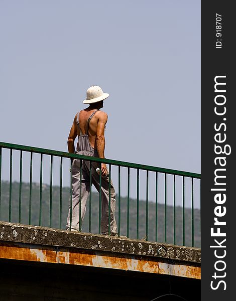 Worker walking by the bridge