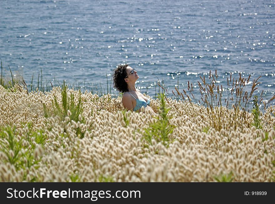 Girl in grass on the coast