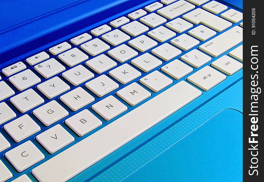 Close up of keyboard on blue laptop computer. Close up of keyboard on blue laptop computer.