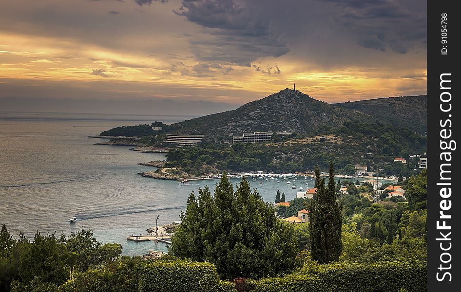 Aerial view of coastal village in hills at sunrise. Aerial view of coastal village in hills at sunrise.