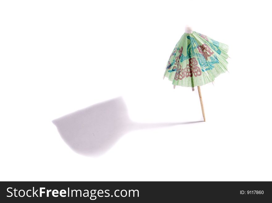 A green cocktail umbrella on white background