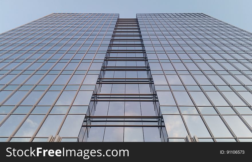 A tall modern office building from the low angle.