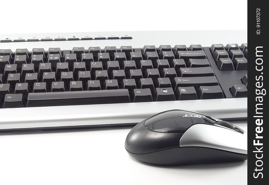 Close up of computer keyboard and mouse in black and white.