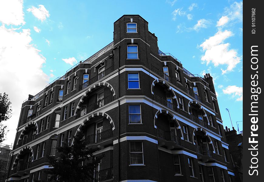 A modern building with arches above balconies. A modern building with arches above balconies.