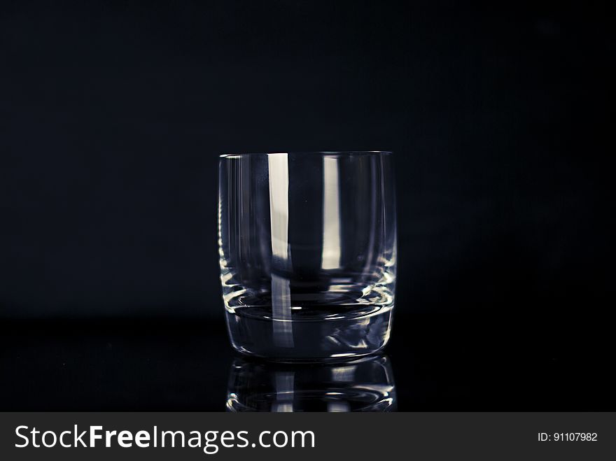 Light reflecting on crystal drinking glass against black. Light reflecting on crystal drinking glass against black.