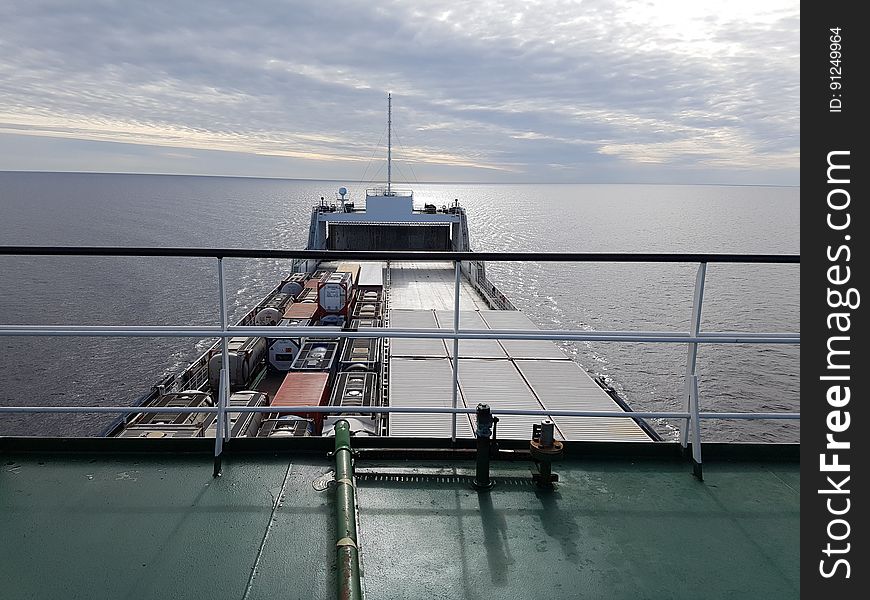 A cargo container ship on the seas seen from the deck.