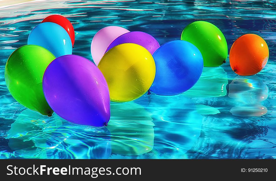 Purple Yellow And Blue Balloon On Swimming Pool