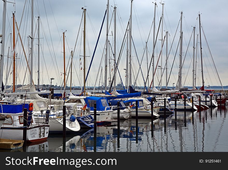 Sailboats docked in the marina in the evening. Sailboats docked in the marina in the evening.