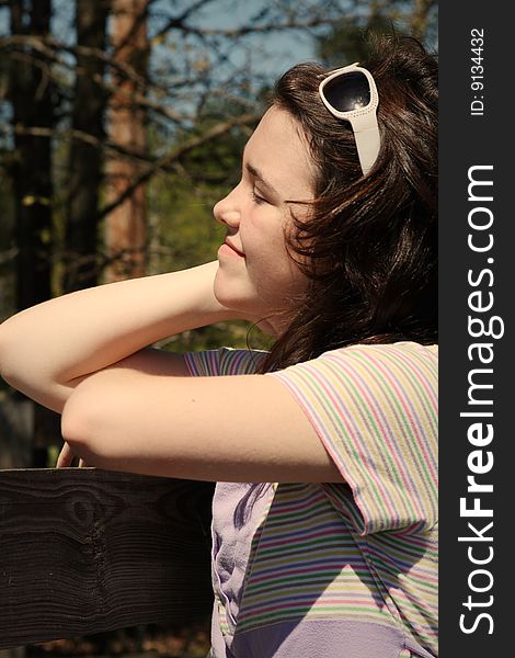 teen girl leaning on wood fence. teen girl leaning on wood fence