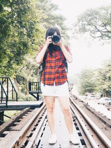 Happy Asian Woman On Vacation Photographing With A Dslr Camera Royalty Free Stock Image Happy Asian Woman On Vacation Photographing With A Dslr Camera Royalty Free Stock Image