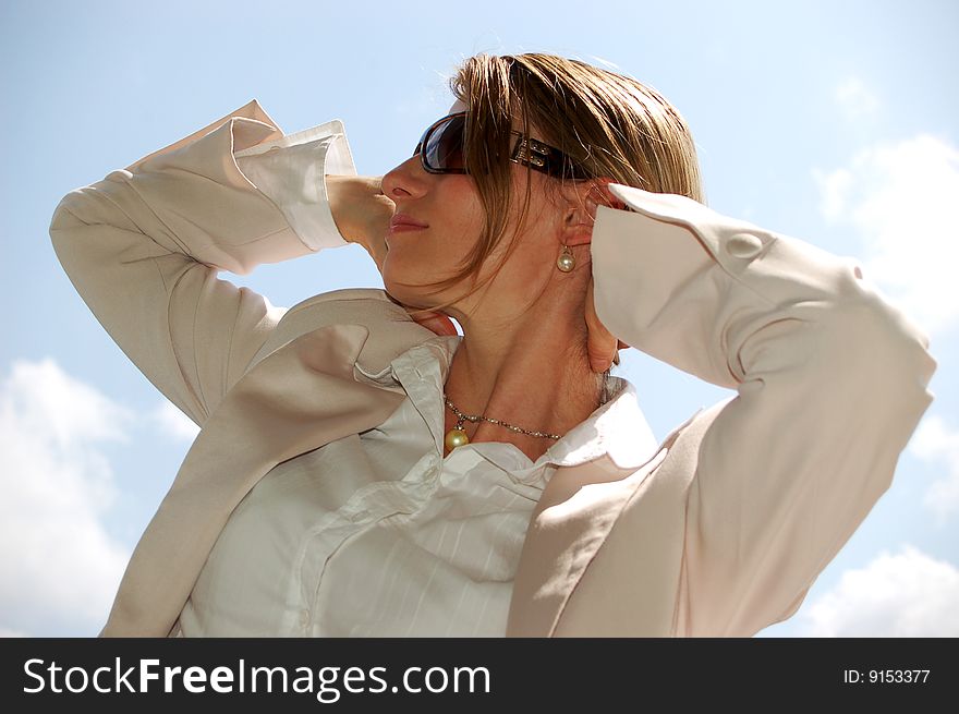 Woman with sunglasses in front of blue sky. Woman with sunglasses in front of blue sky