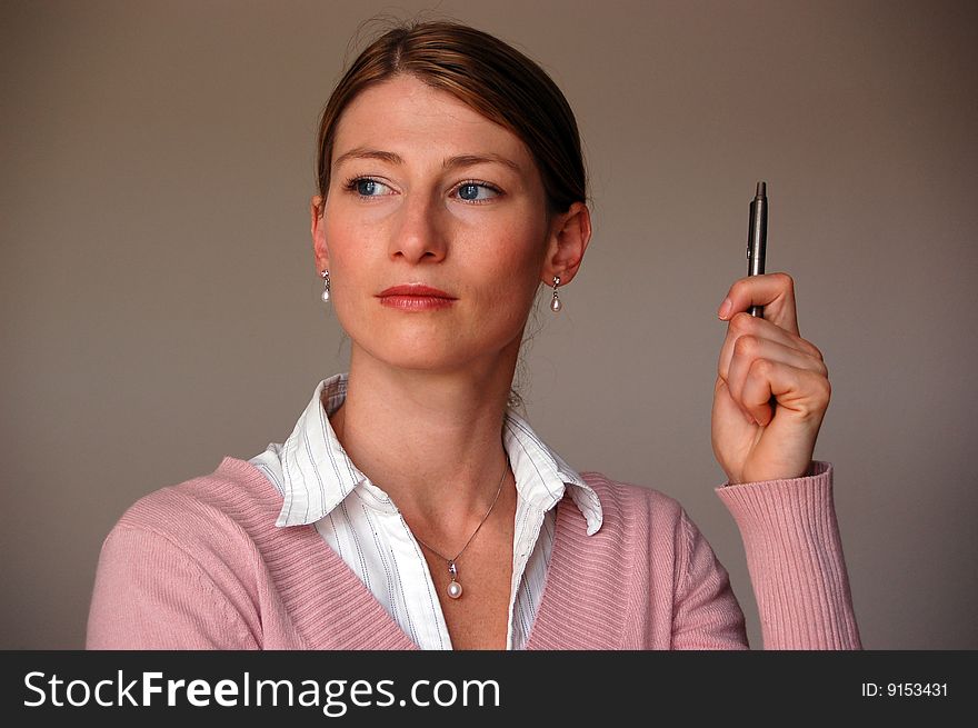 Attractive thoughtful women holding a pen. Attractive thoughtful women holding a pen