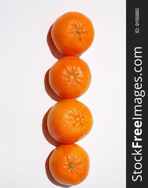 Delicious and juicy orange tangerines grouped together vertically and isolated on white. Delicious and juicy orange tangerines grouped together vertically and isolated on white.