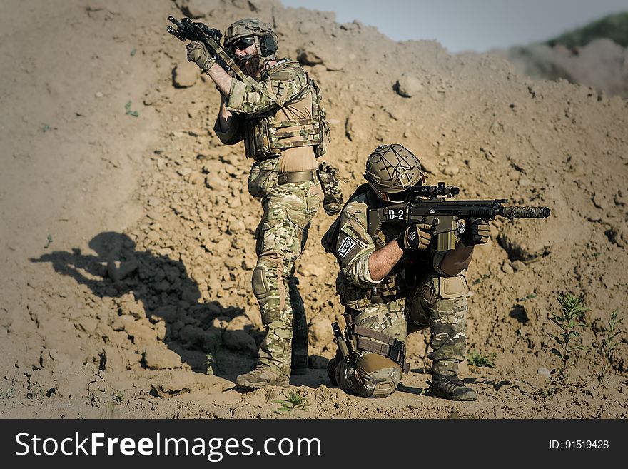 Two Men in Army Uniforms With Guns