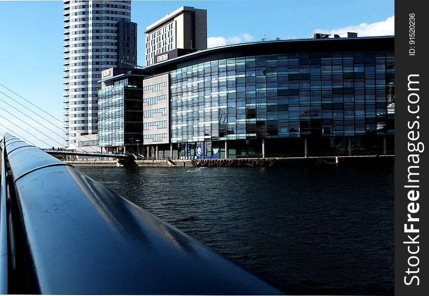 A view of modern office buildings on a river bank. A view of modern office buildings on a river bank.